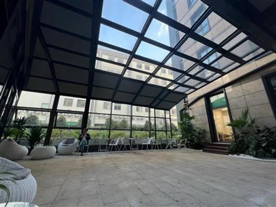 Curved Glass Sunroom With Retractable Roof